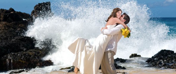 Wedding couple by the ocean waves