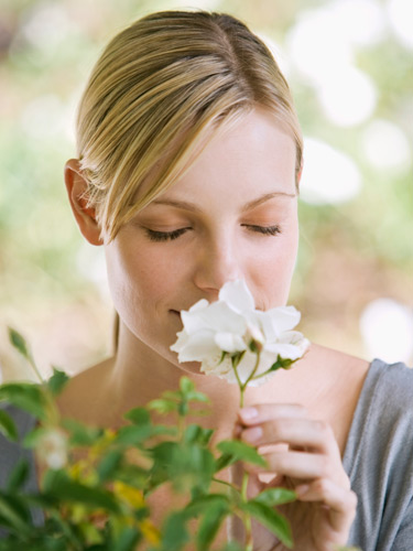 woman smelling gardenia
